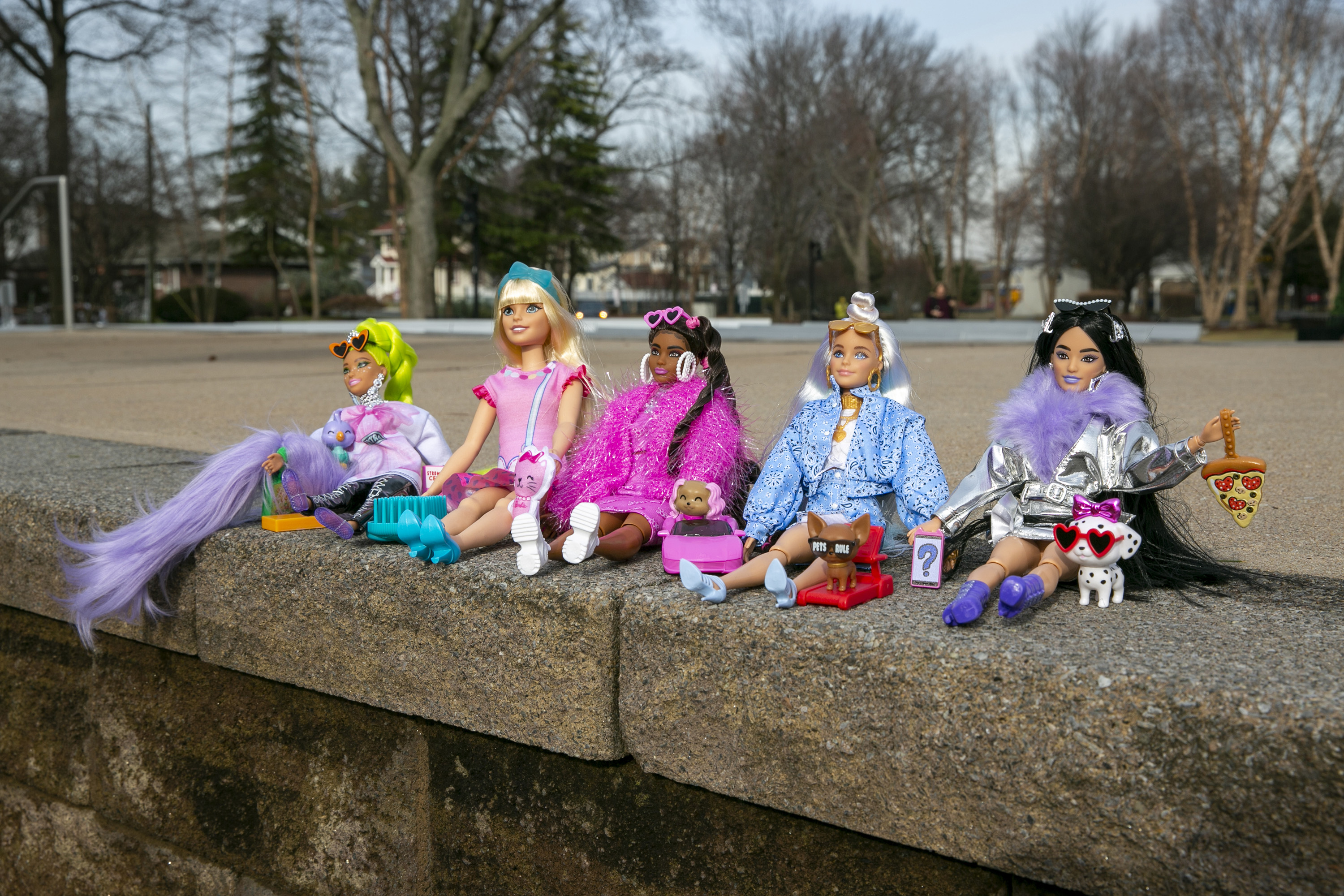 Mattel's first Barbie doll for preschool children, second from left, called My First Barbie, sits with a collection of Barbie Extra dolls in Lyndhurst, New Jersey, on Wednesday, Jan. 4, 2022. The preschool Barbie is taller and softer than regular Barbies, with long rooted hair, younger features and more flexible hands and legs. The Barbie Extra dolls are curvier and come with pets and other accessories.