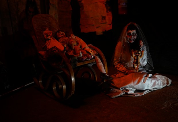 A woman dressed as "Killer Bride" performs at a House of Terror during a Day of the Dead night in La Paz, Bolivia, Tuesday, Oct. 31, 2023. People, mostly of Aymara descent, have started to embrace Halloween celebrations introducing characters adapted from their own culture. (AP Photo/Juan Karita)