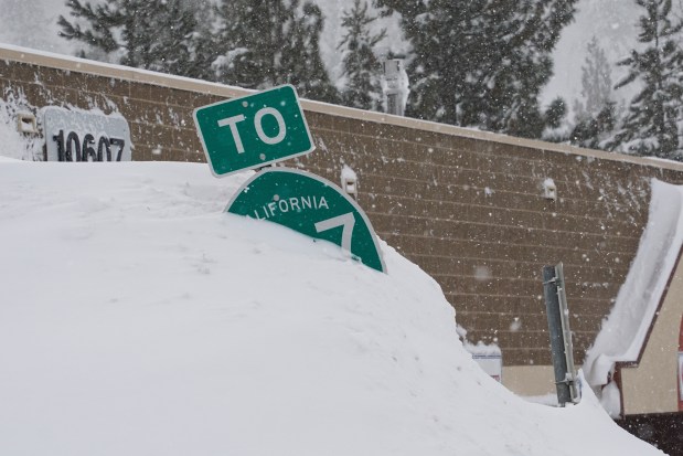 A highway sign is covered in snow during a storm, Sunday, March 3, 2024, in Truckee, Calif. (AP Photo/Brooke Hess-Homeier)