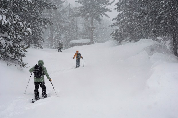 People ski during a snow storm, Sunday, March 3, 2024, in Olympic Valley, Calif. (AP Photo/Brooke Hess-Homeier)