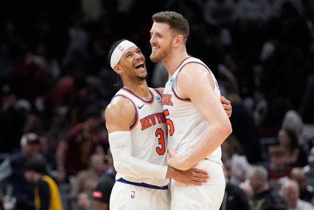 New York Knicks guard Josh Hart (3) and center Isaiah Hartenstein, right, celebrate as the Knicks defeat the Cleveland Cavaliers in an NBA basketball game, Sunday, March 3, 2024, in Cleveland. (AP Photo/Sue Ogrocki)