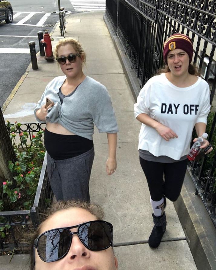Mom-to-be Amy Schumer looks like she's taking her pregnancy in stride. The comedian took to Instagram on Nov. 1, 2018 to post a photo of herself and two friends out for a walk, where she playfully lifted her shirt to show off her growing baby bump.