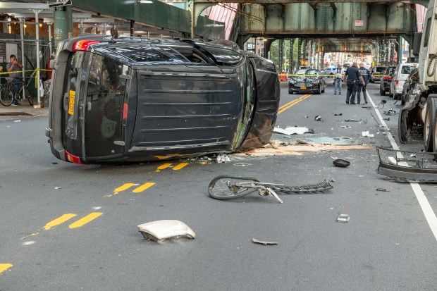 A man on a bicycle who was reportedly breaking into cars was rushed to hospital in critical condition after a man driving a Jeep Grand Cherokee SUV chased him down and crushed him into two parked cars and a tractor before flipping the SUV on Broadway near Ellery Street in Brooklyn on Monday September 2, 2019. 0740. Reports indicate the driver was promptly arrested. (Theodore Parisienne for New York Daily News)
