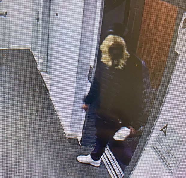 A still from surveillance footage taken inside the Highbridge building shows a man standing outside the scene of the crime. (Obtained by Daily News)