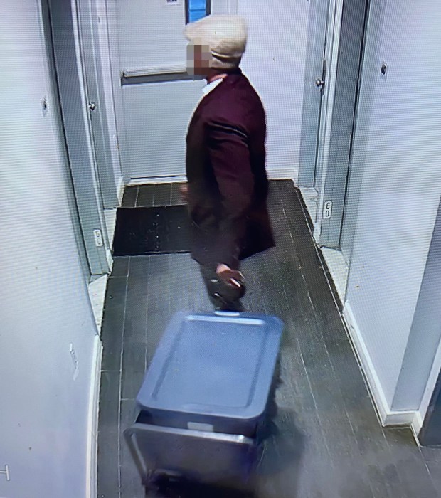 A still from surveillance footage taken inside the Highbridge building shows a man standing outside the scene of the crime. (Obtained by Daily News)