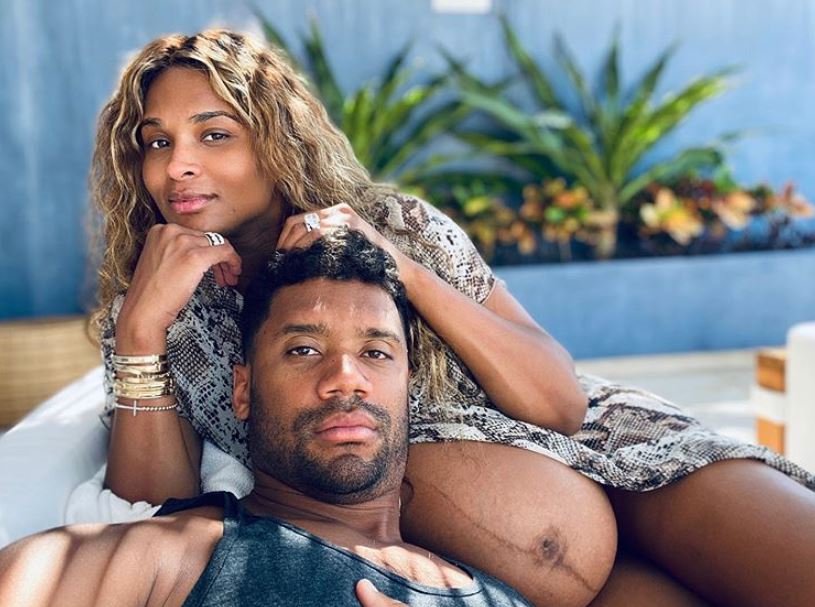 Ciara, looking unbothered and in love, showed off her baby bump in a sunny photo with husband Russell Wilson on June 26, 2020.