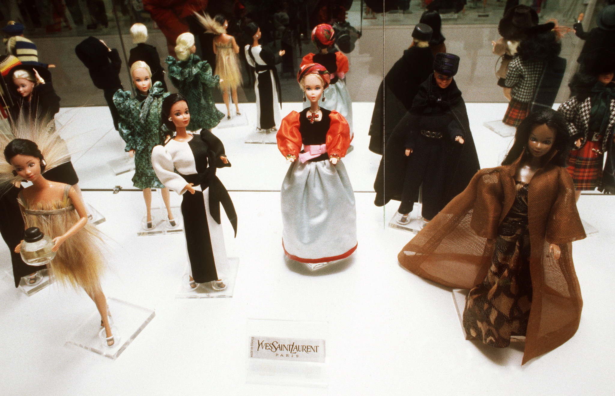 After being introduced wearing a chic black and white swimsuit, it's no wonder Barbie became a fashion icon and muse to many designers. Here, multiple dolls wear miniature outfits designed by Yves Saint Laurent in Paris on Jan. 1, 1989.