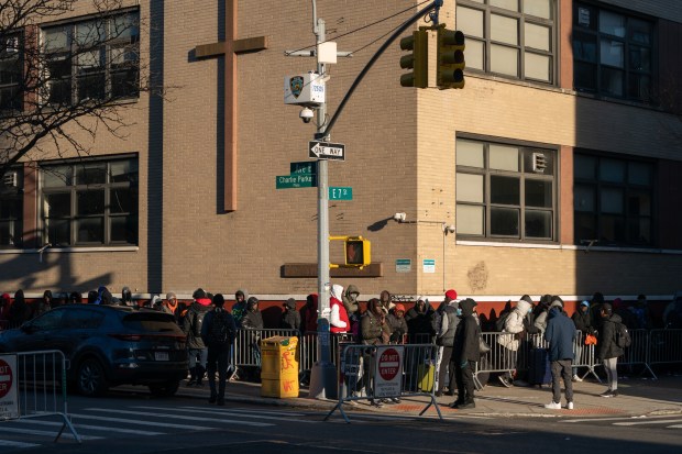 Migrants line up outside a migrant re-ticketing center at St. Brigid School on E. 7th St. Friday, Jan. 5, 2024 in Manhattan. (Barry Williams for New York Daily News)