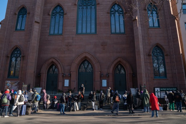 Migrants line up on Ave. B to get into a migrant re-ticketing center at St. Brigid School on E. 7th St. Friday, Jan. 5, 2024 in Manhattan. (Barry Williams for New York Daily News)