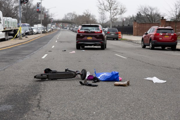 NYPD investigate the scene where a female electric scooter rider collided with a vehicle while crossing on the crosswalk on the corner of Blossom Ave and College Point Blvd., Queens, New York on Wednesday, Mar. 6, 2024. (Shawn Inglima for New York Daily News)
