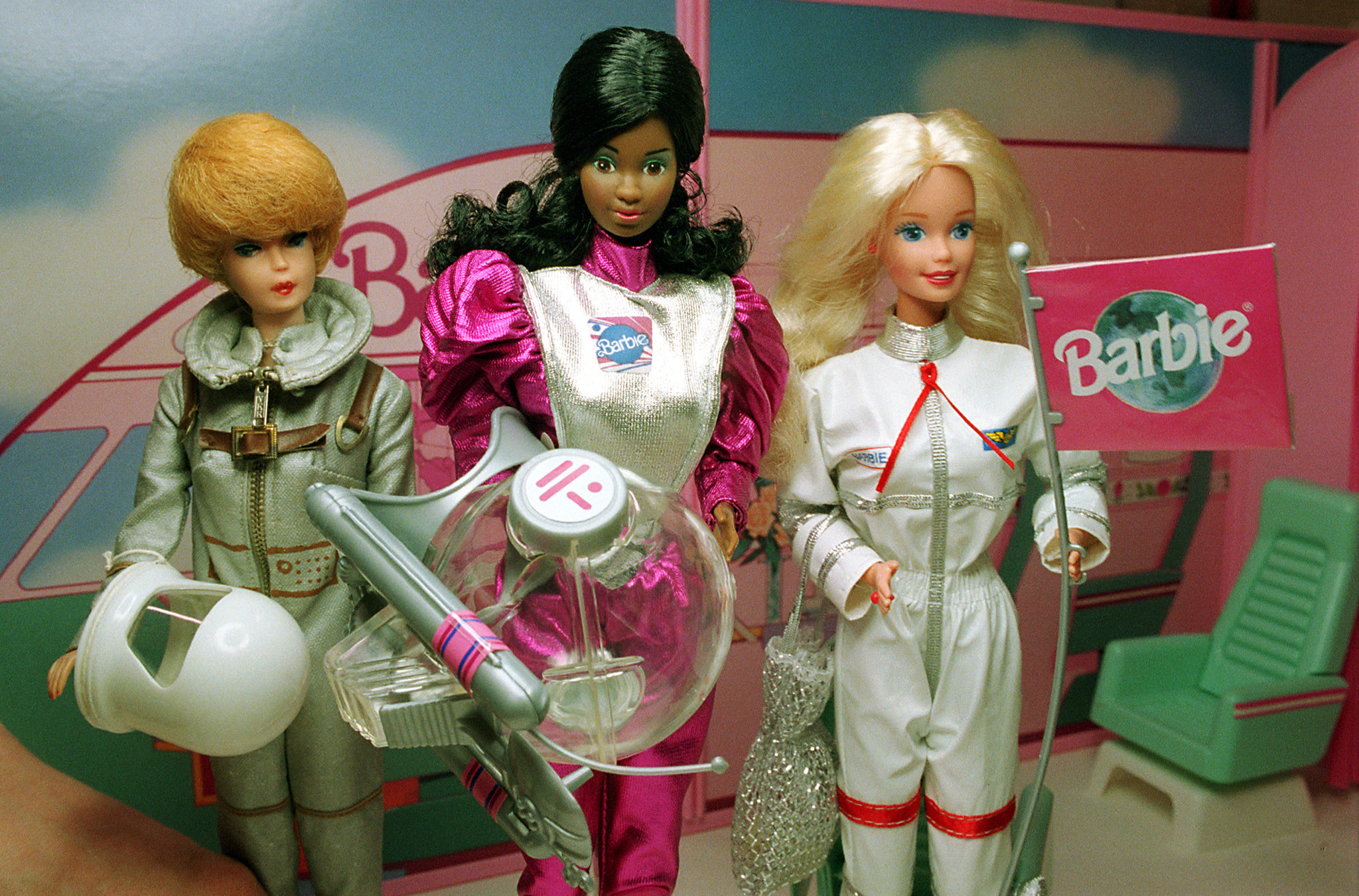 Astronaut Barbie dolls, from left, the 1960s, 1980s and 1990s, sit on display at the Smithsonian's National Air and Space Museum in Washington, D.C. on May 1, 1995. Barbie as a character is known for her many professions.