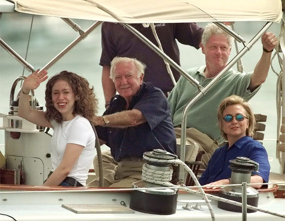 President Clinton waves as he sails with wife Hillary and daughter Chelsea aboard a sailboat skippered by former CBS Anchor Walter Cronkite on Aug. 25, 1998, near Edgartown, Mass.