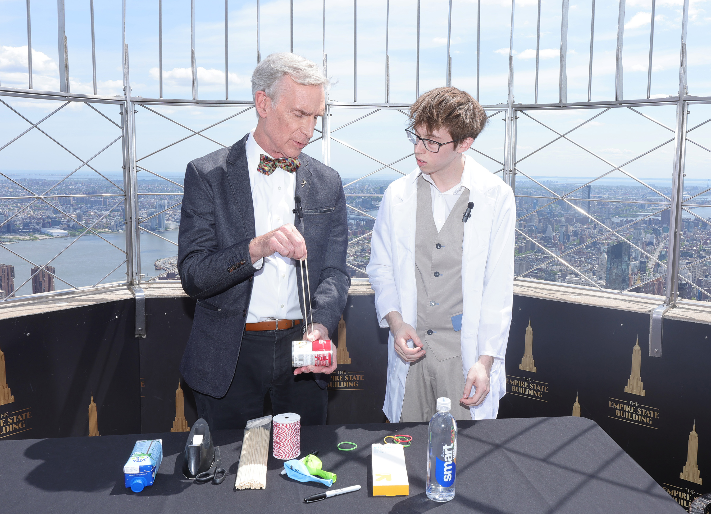 Bill Nye and Thomas Edwards conduct a science experiment at the top of the Empire State Building during a visit on May 8, 2023, in New York City.